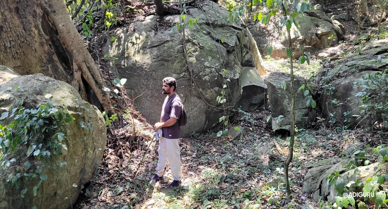 A spiritual documentary filmmaker standing before an ancient Indian temple, symbolizing the journey behind ADIGURU and the exploration of timeless spirituality.